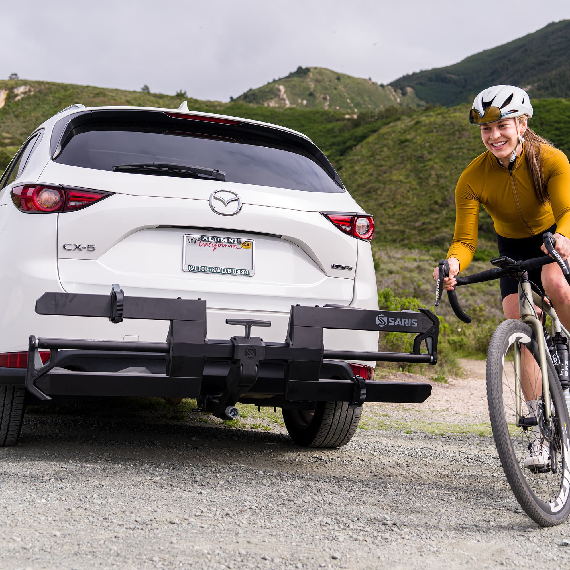 Lifestyle picture of SuperClamp G4 on back of SUV with a person biking on road